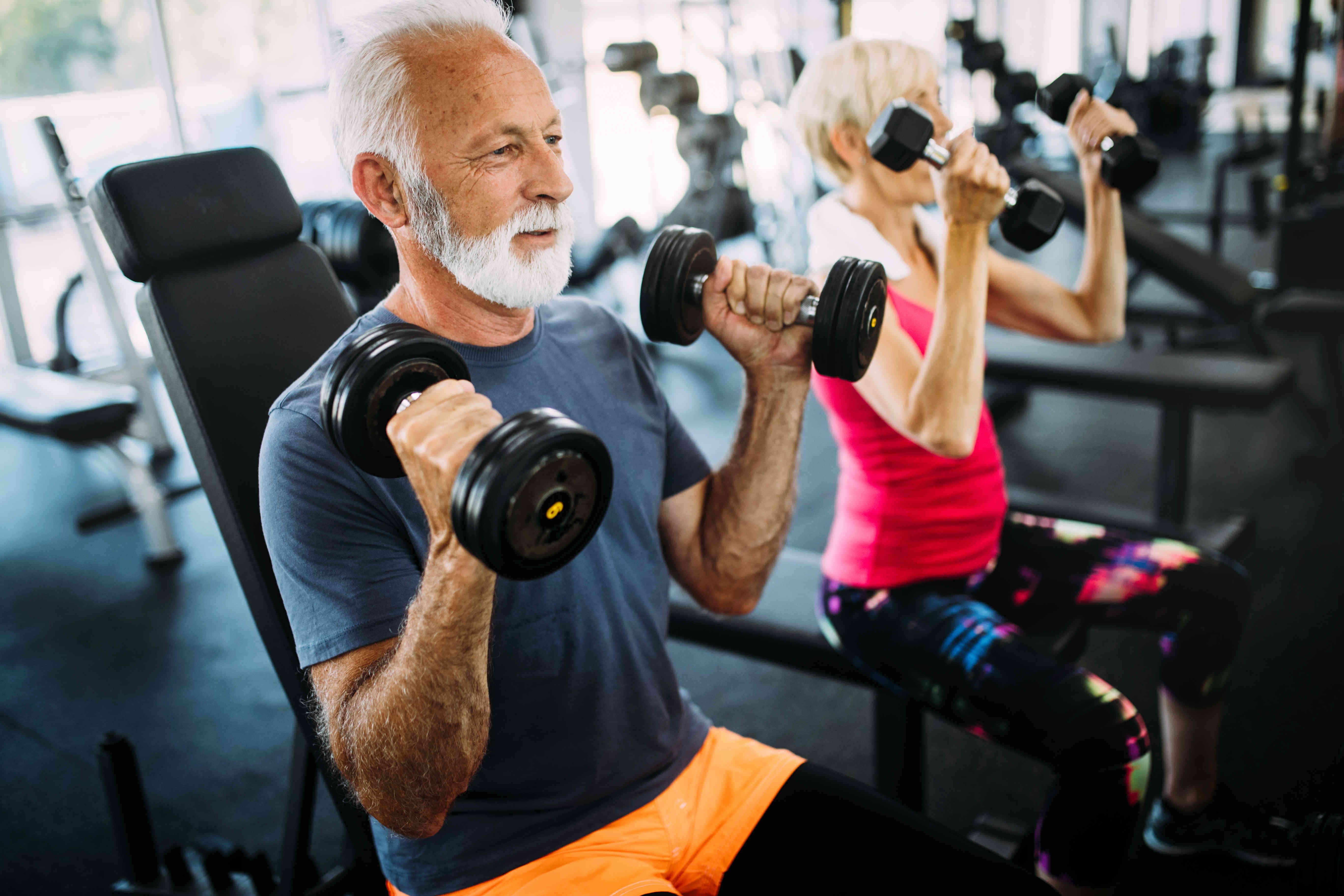 Older people exercise with weights.
