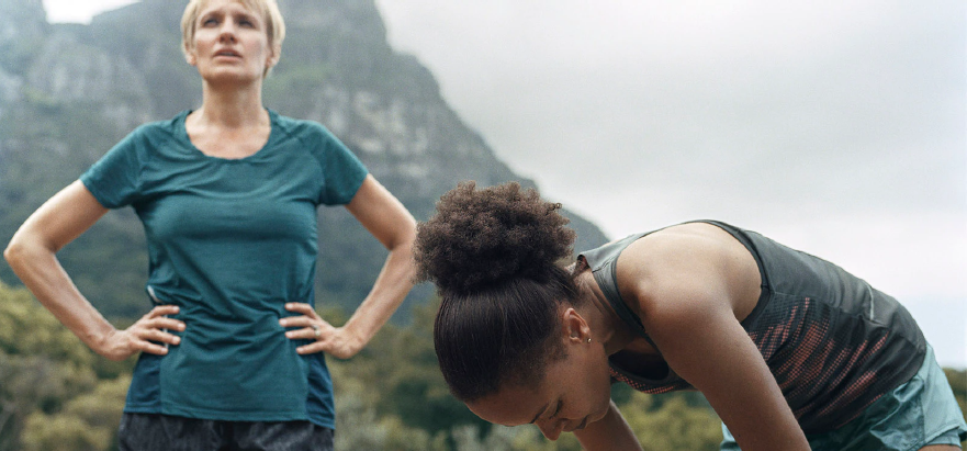 Two women take a break during outdoor running workout