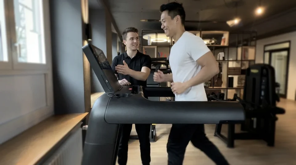 Physiotherapist guiding a patient through treadmill training