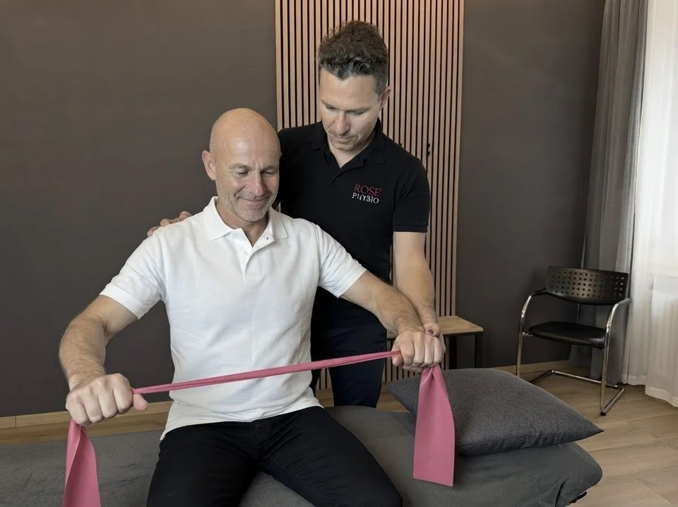 Strength exercise with a resistance band on a treatment table
